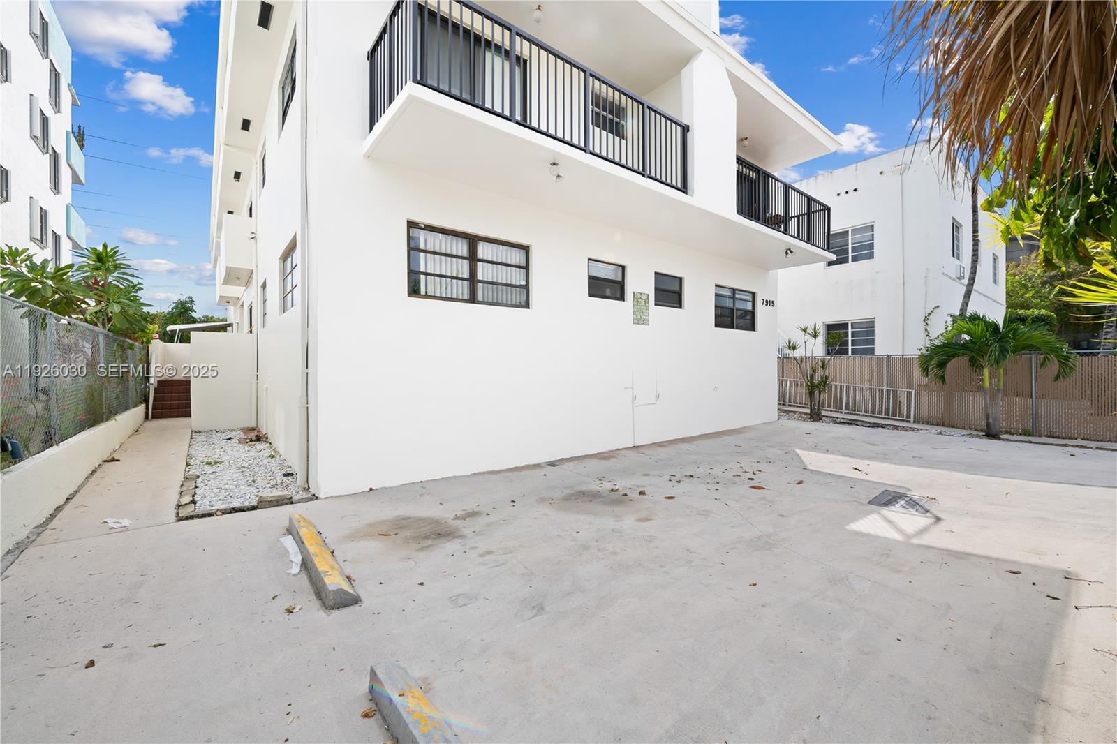 7915 Harding Avenue, Unit 1 Miami Beach, FL 33141 - Photo 18 of 25 a view of a white house with a yard