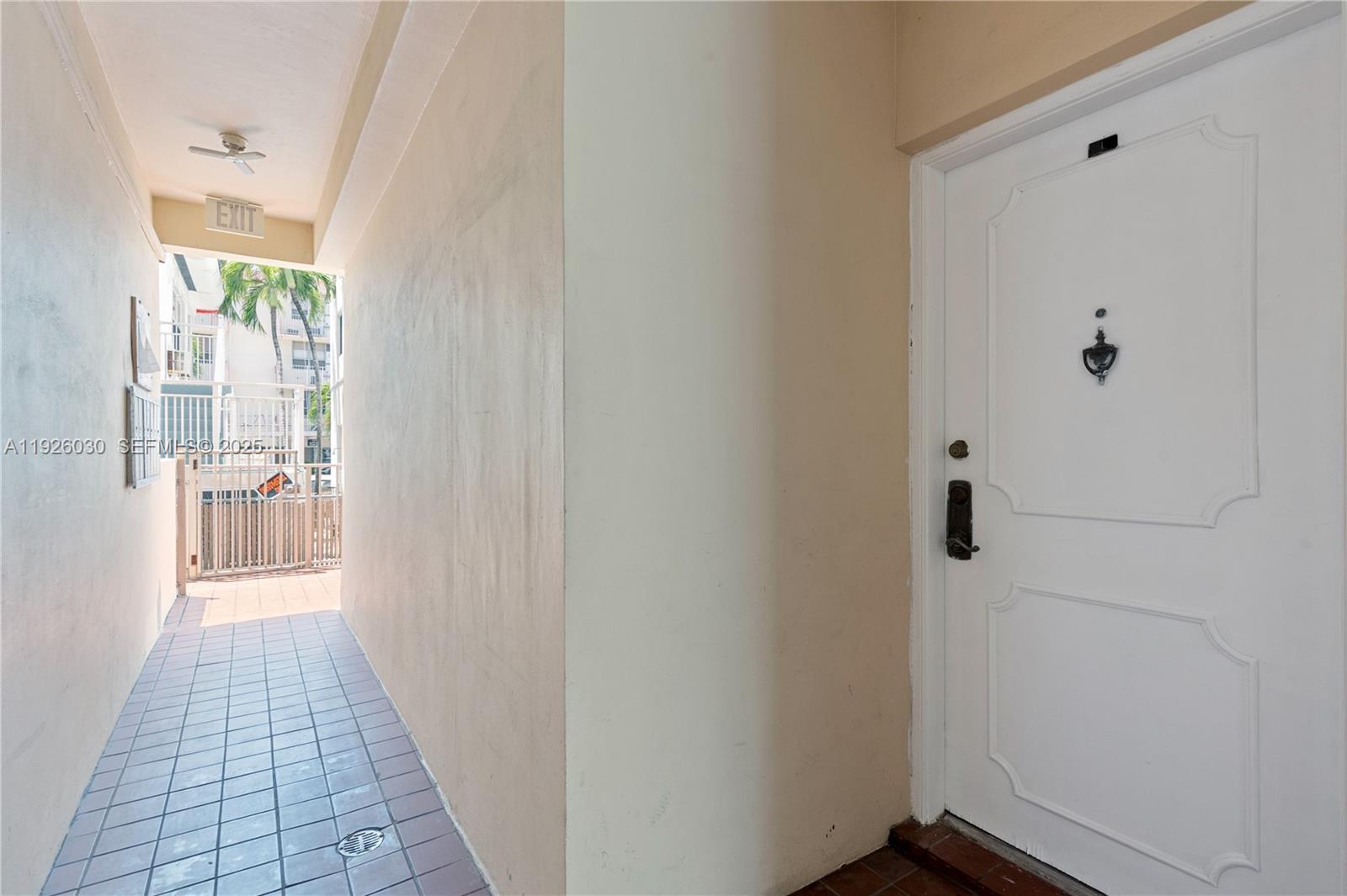 7915 Harding Avenue, Unit 1 Miami Beach, FL 33141 - Photo 2 of 25 a view of a hallway with wooden floor and a bathroom