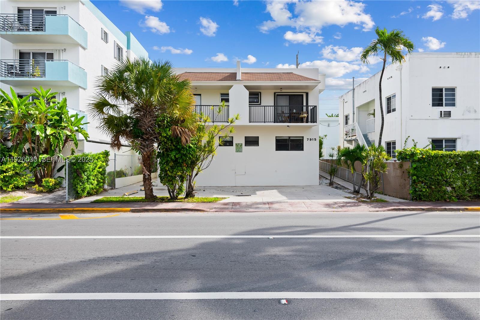 7915 Harding Avenue, Unit 1 Miami Beach, FL 33141 - Photo 21 of 25 a front view of a house with a yard and garage