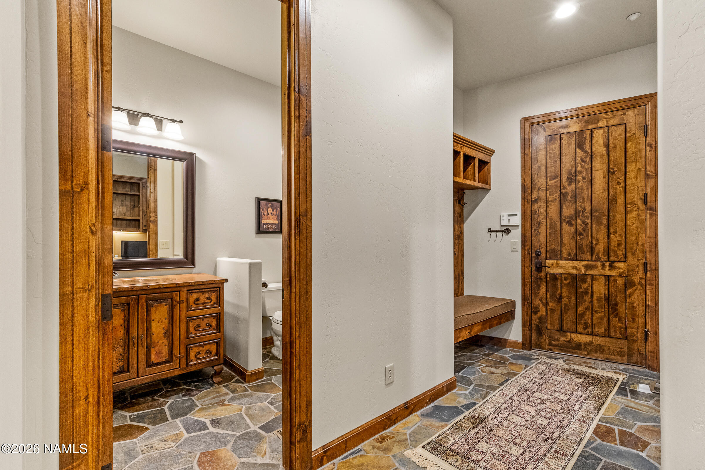 2214 East Del Rae Drive Flagstaff, AZ 86005 - Photo 30 of 45 a view of a hallway with wooden floor and a bedroom