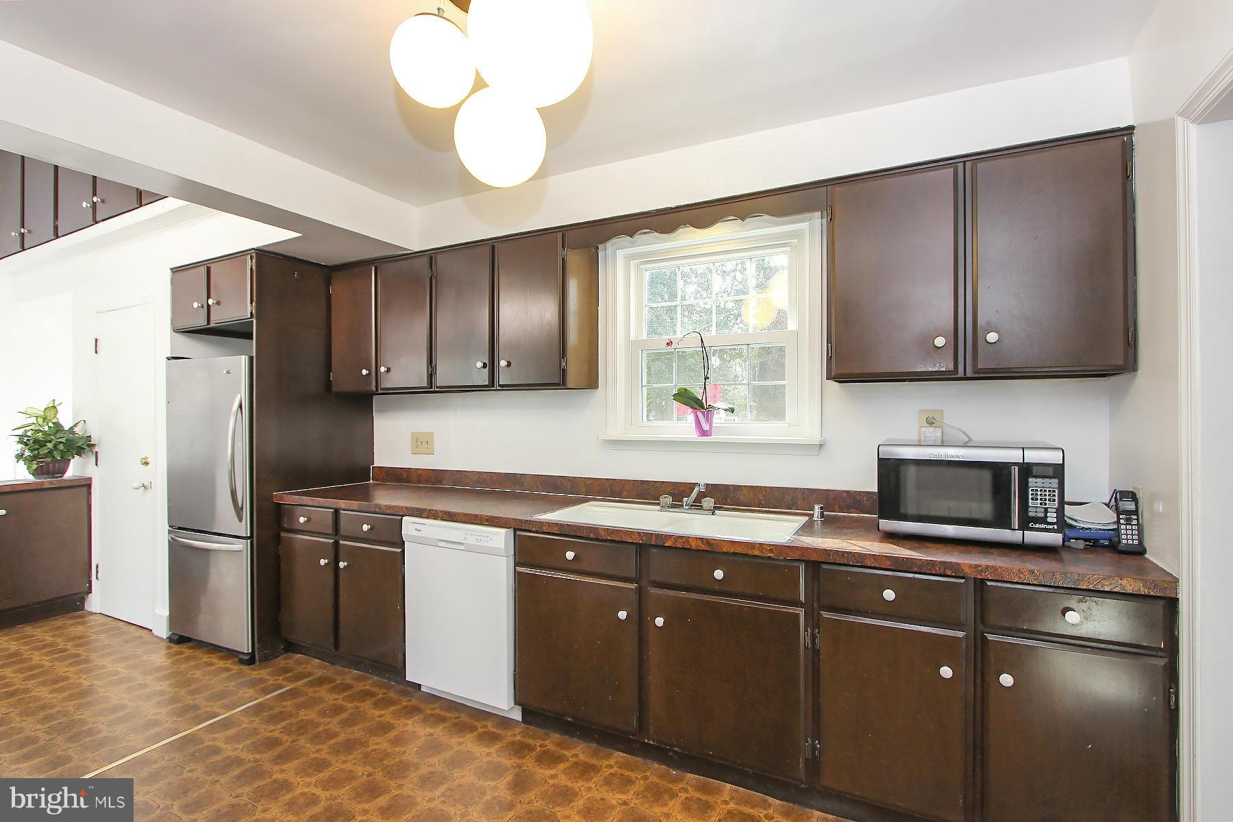 1111 Notley Road Silver Spring, MD 20904 - Photo 13 of 30 a kitchen with stainless steel appliances granite countertop a sink a stove a refrigerator cabinets and a window