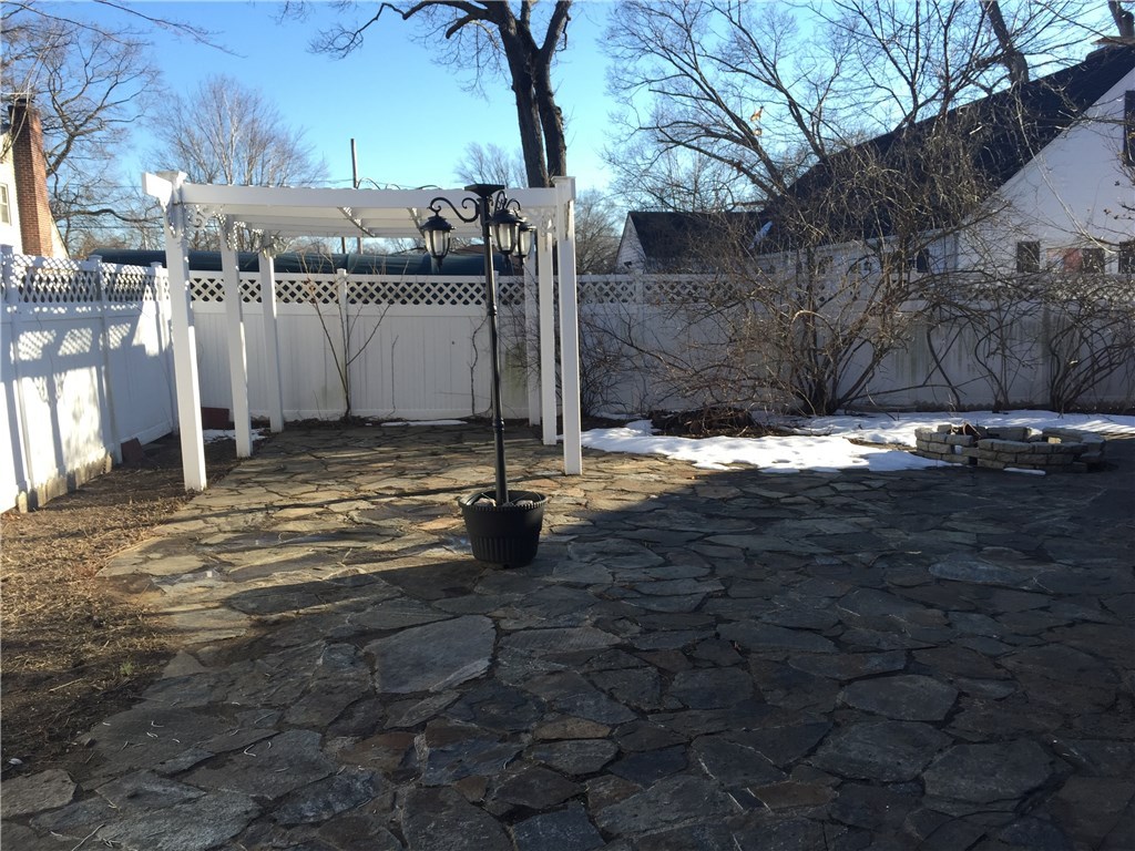 152 Edgehill Road Warwick, RI 02889 - Photo 24 of 24 Small backyard, mostly patio with firepit and arbor