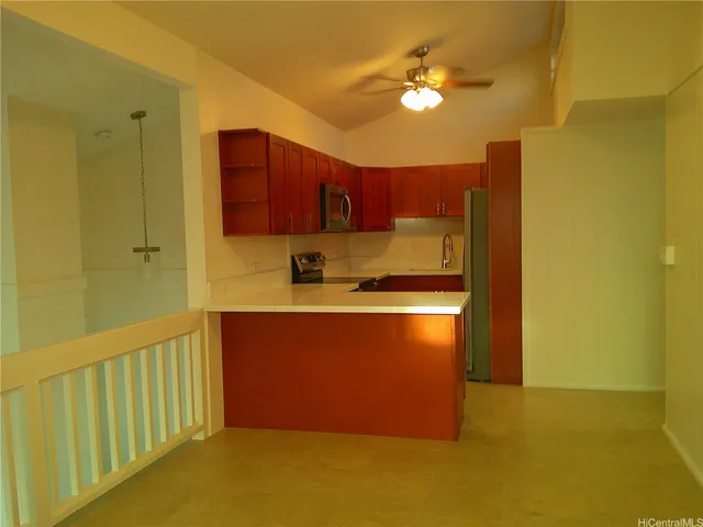 a kitchen with stainless steel appliances granite countertop a refrigerator a stove and a sink