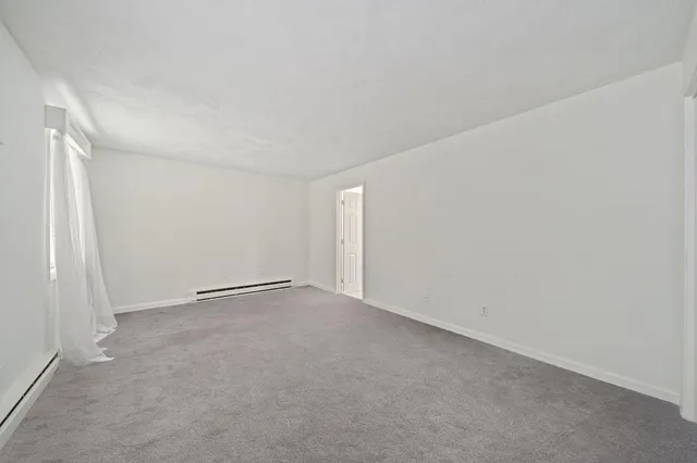 a view of an empty room and a window