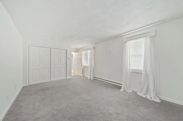 a view of an empty room and closet area