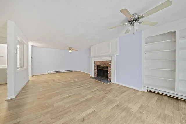 a view of an empty room with a fireplace
