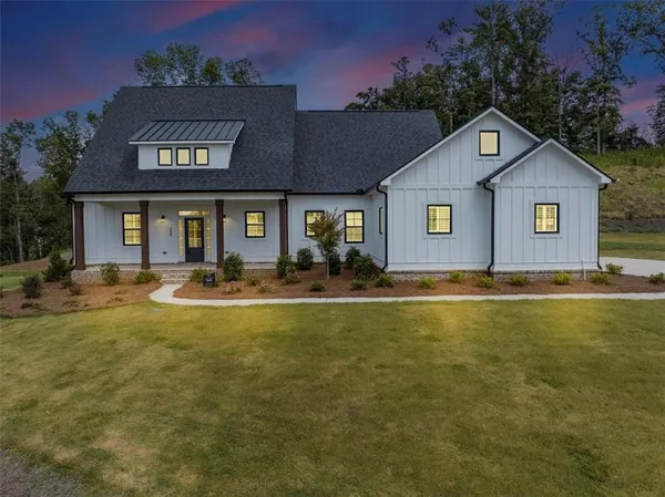 a front view of house with yard and outdoor seating