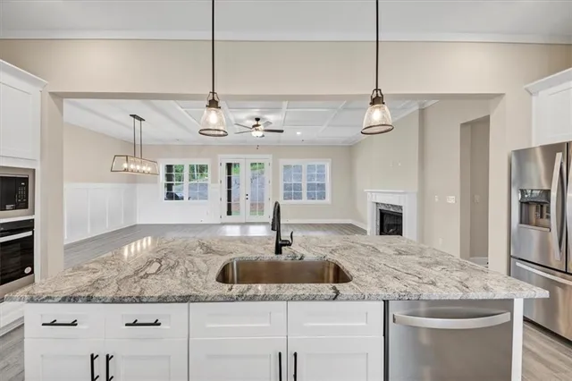 a kitchen with living cabinets a sink and dishwasher