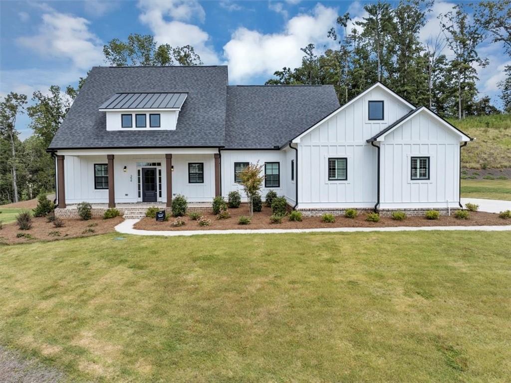 354 Oxford Road Ball Ground, GA 30107 - Photo 2 of 48 a front view of house with yard and trees around