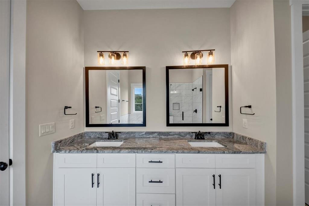 354 Oxford Road Ball Ground, GA 30107 - Photo 24 of 48 a bathroom with a granite countertop sink and a mirror