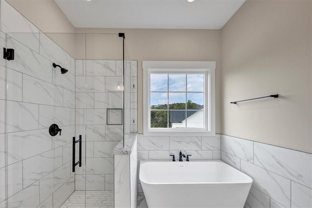 354 Oxford Road Ball Ground, GA 30107 - Photo 25 of 48 a bathroom with a bathtub and shower
