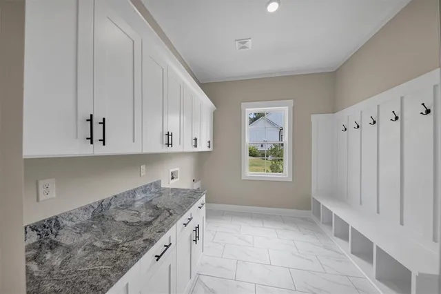 a kitchen with granite countertop a sink a stove and a refrigerator