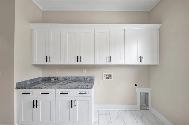 a kitchen with granite countertop white cabinets and a sink