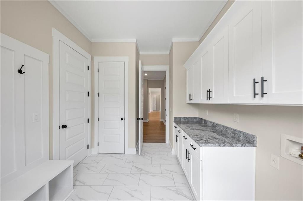 354 Oxford Road Ball Ground, GA 30107 - Photo 37 of 48 a spacious bathroom with a granite countertop sink and a mirror