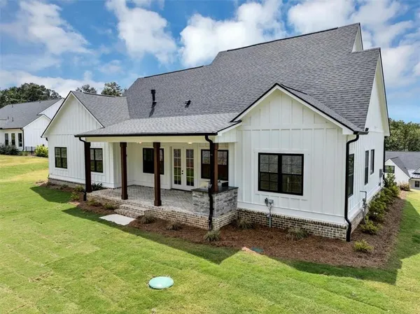a view of a house with backyard porch and sitting area