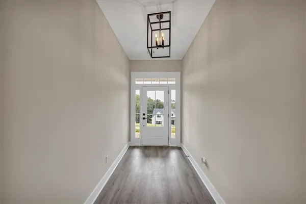a view of an entryway with wooden floor