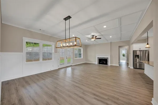 a view of a livingroom with a ceiling fan window and wooden floor
