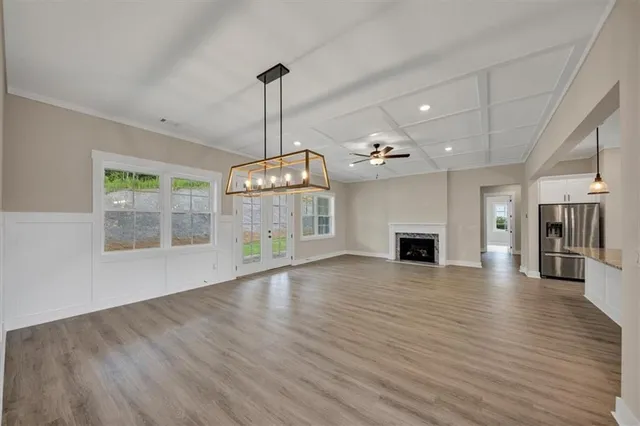 a view of a livingroom with a ceiling fan window and wooden floor