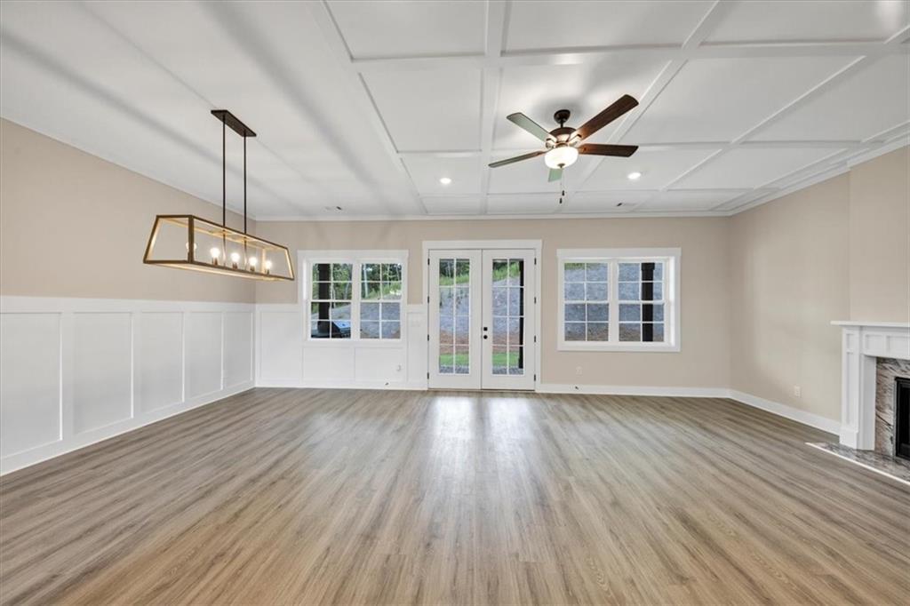 354 Oxford Road Ball Ground, GA 30107 - Photo 8 of 48 a view of an empty room with wooden floor and a window