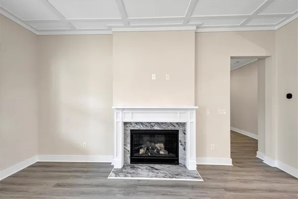 a view of a livingroom with a fireplace and a window