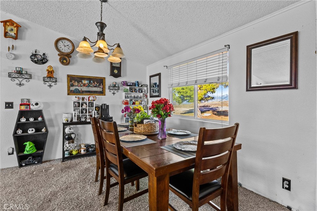 33945 Red Mountain Road Hemet, CA 92544 - Photo 25 of 30 a dining room with furniture and painting on the wall