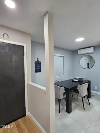 a view of a room that has a table and chairs