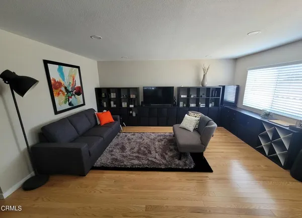 a living room with furniture rug and window