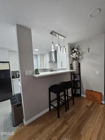 a dining room with furniture and wooden floor