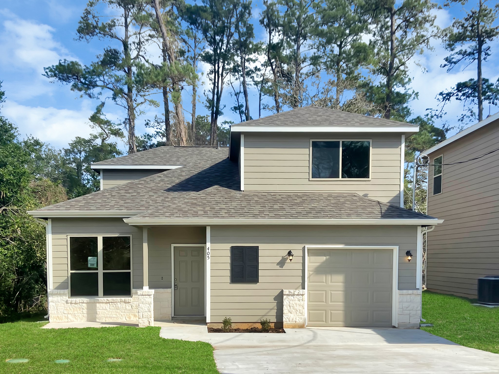 405 Mohawk Drive Conroe, TX 77316 - Photo 1 of 22 a front view of a house with a garden