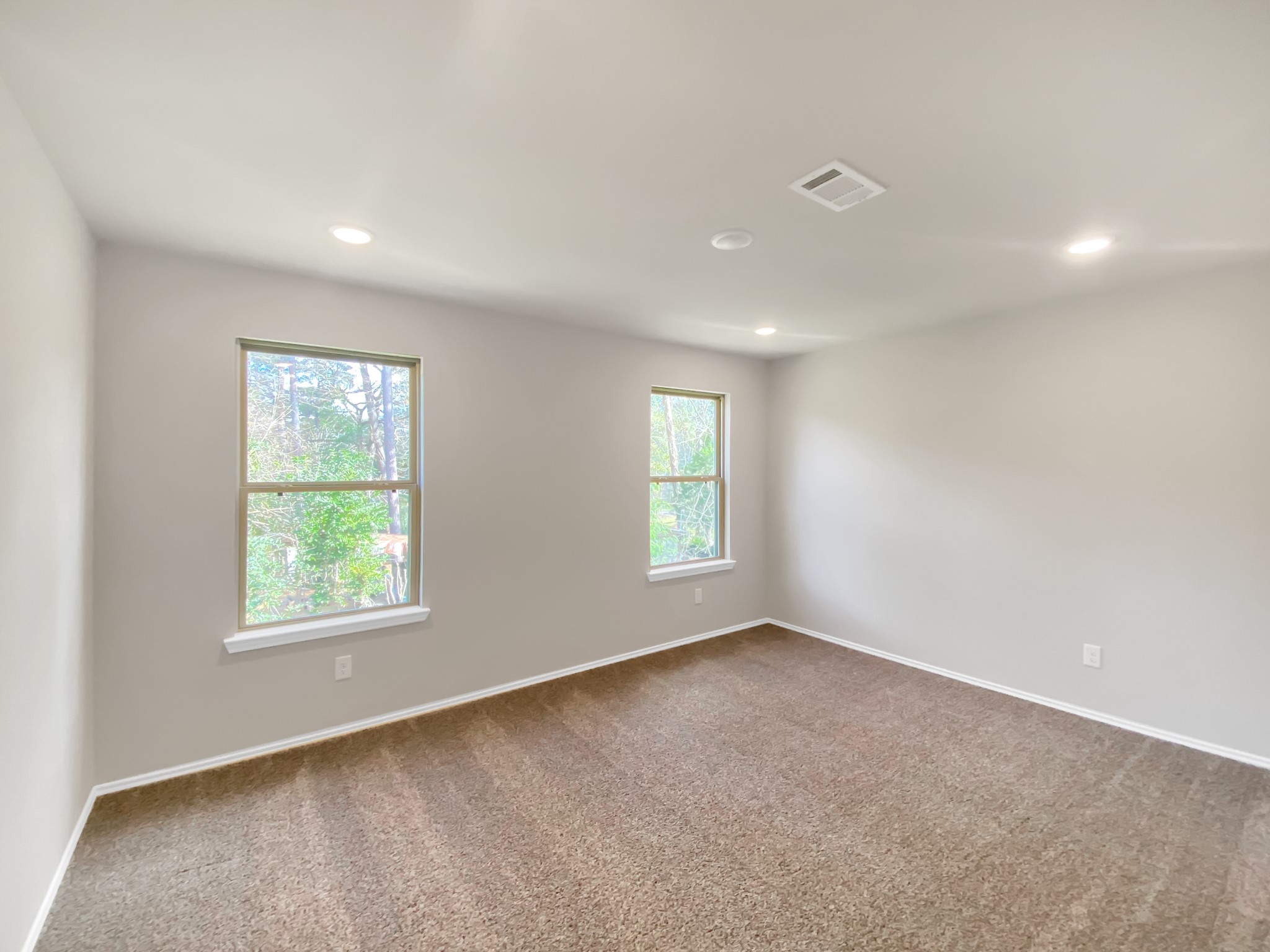 405 Mohawk Drive Conroe, TX 77316 - Photo 20 of 22 a view of a big room with windows and chandelier fan