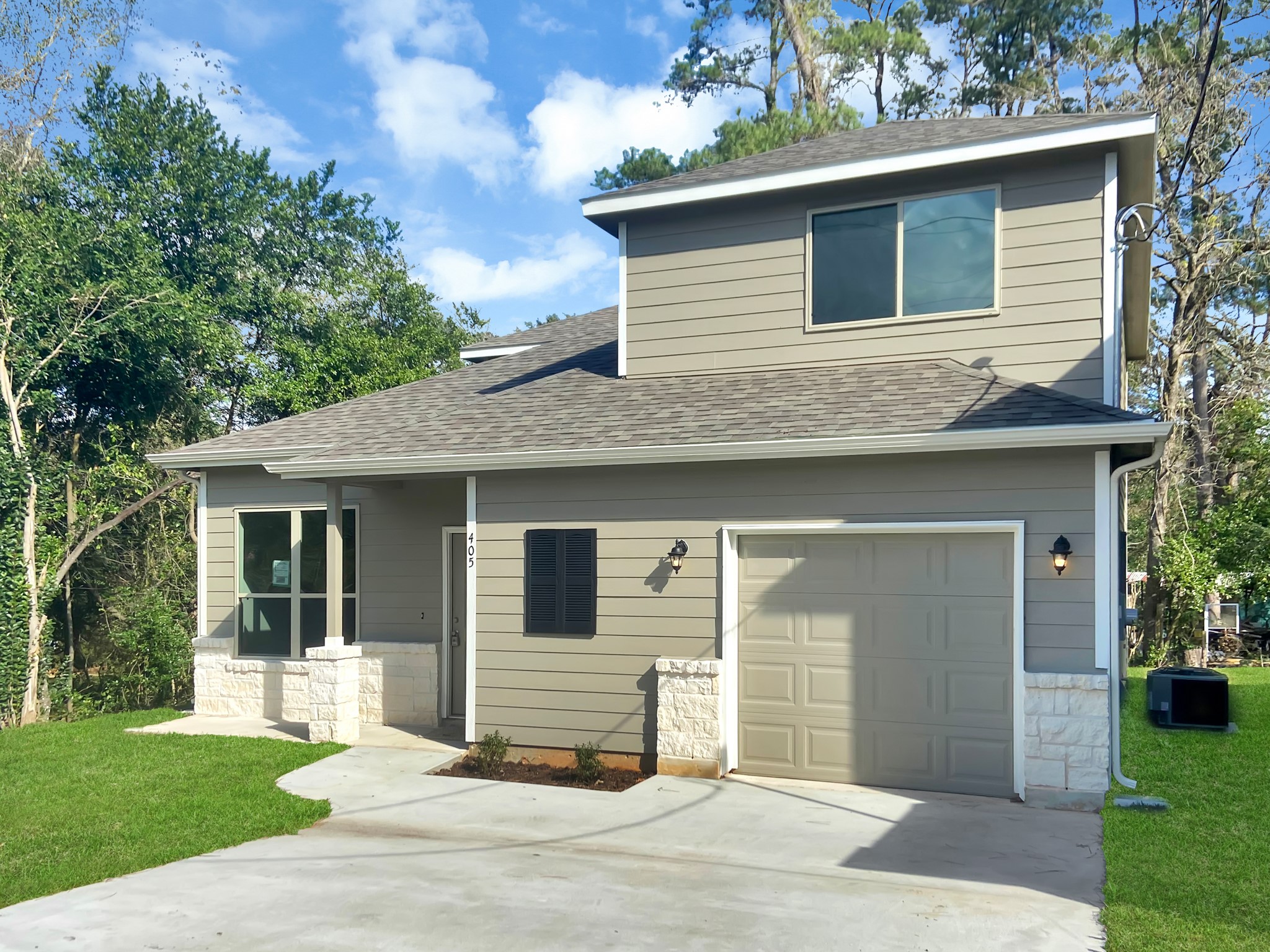 405 Mohawk Drive Conroe, TX 77316 - Photo 2 of 22 a house that has a tree in front of the house