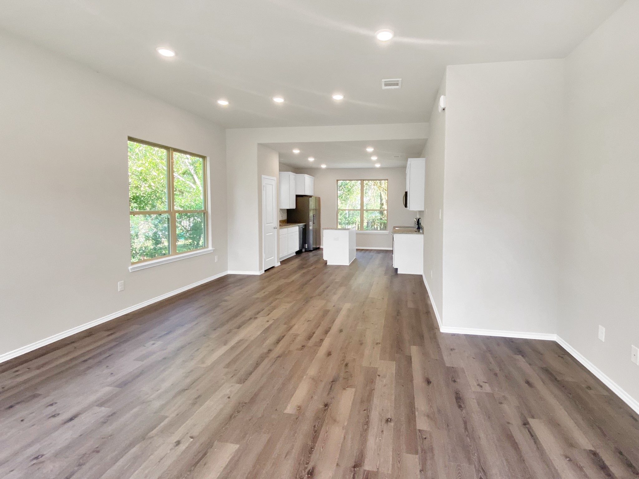 405 Mohawk Drive Conroe, TX 77316 - Photo 5 of 22 a view of an empty room with wooden floor and a window