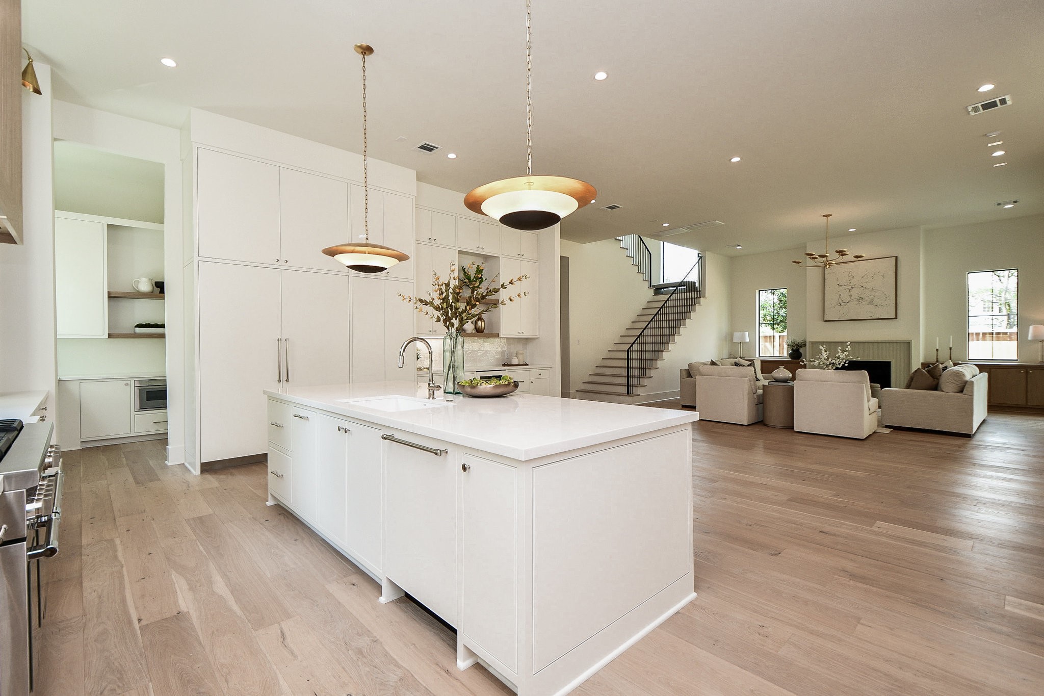 336 West 32nd Street Houston, TX 77018 - Photo 13 of 50 a large white kitchen with a lot of counter space and a wooden floor