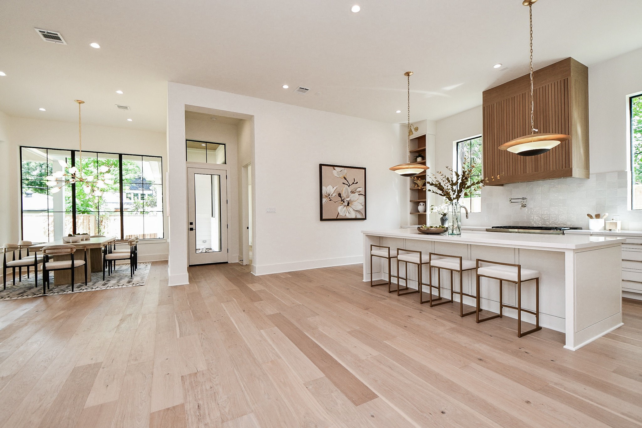 336 West 32nd Street Houston, TX 77018 - Photo 18 of 50 a dining room with kitchen island stainless steel appliances furniture and a wooden floor