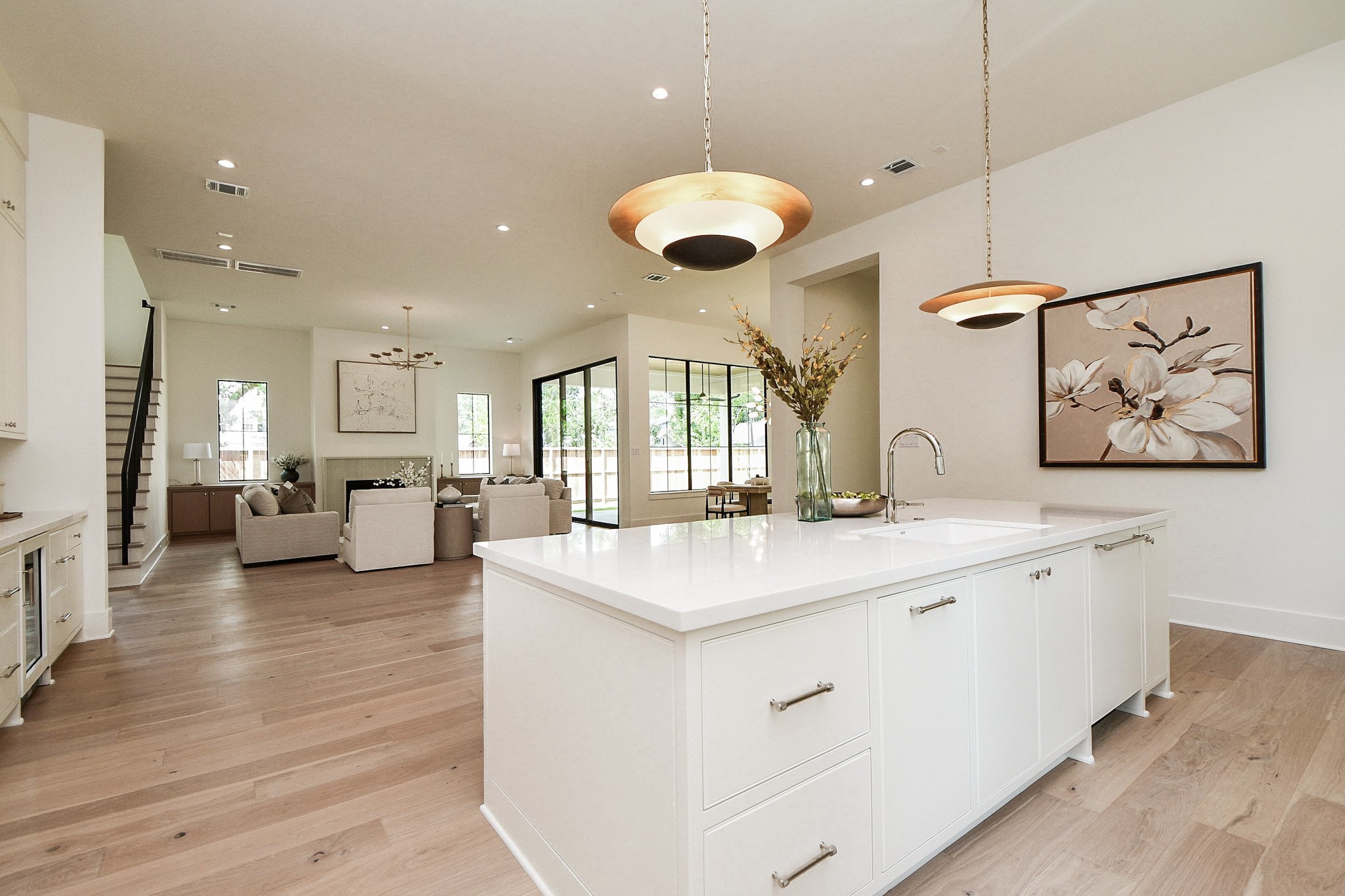 336 West 32nd Street Houston, TX 77018 - Photo 19 of 50 a large white kitchen with a large island oven a stove and a wooden floors