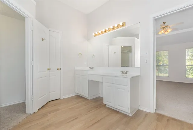 a bathroom with a sink vanity and a mirror