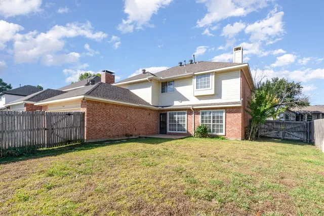 a view of a house with a yard and porch