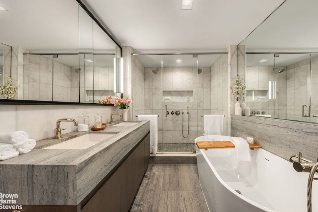 74 Grand Street, Unit PH Manhattan, NY 10013 - Photo 12 of 18 a bathroom with a sink a mirror and a bathtub