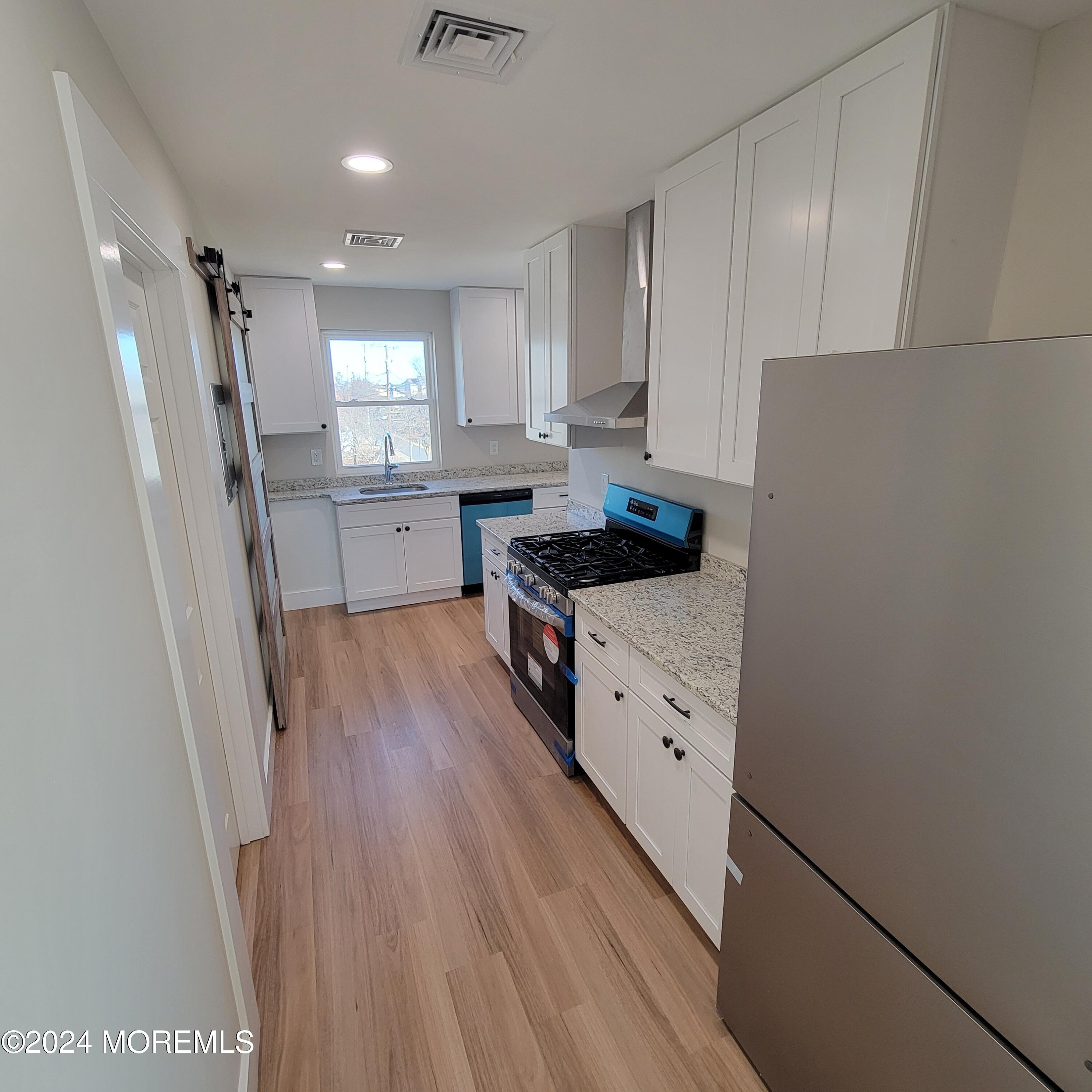 603 Florence Avenue, Unit 2 Union Beach, NJ 07735 - Photo 1 of 11 a kitchen with white cabinets and white appliances