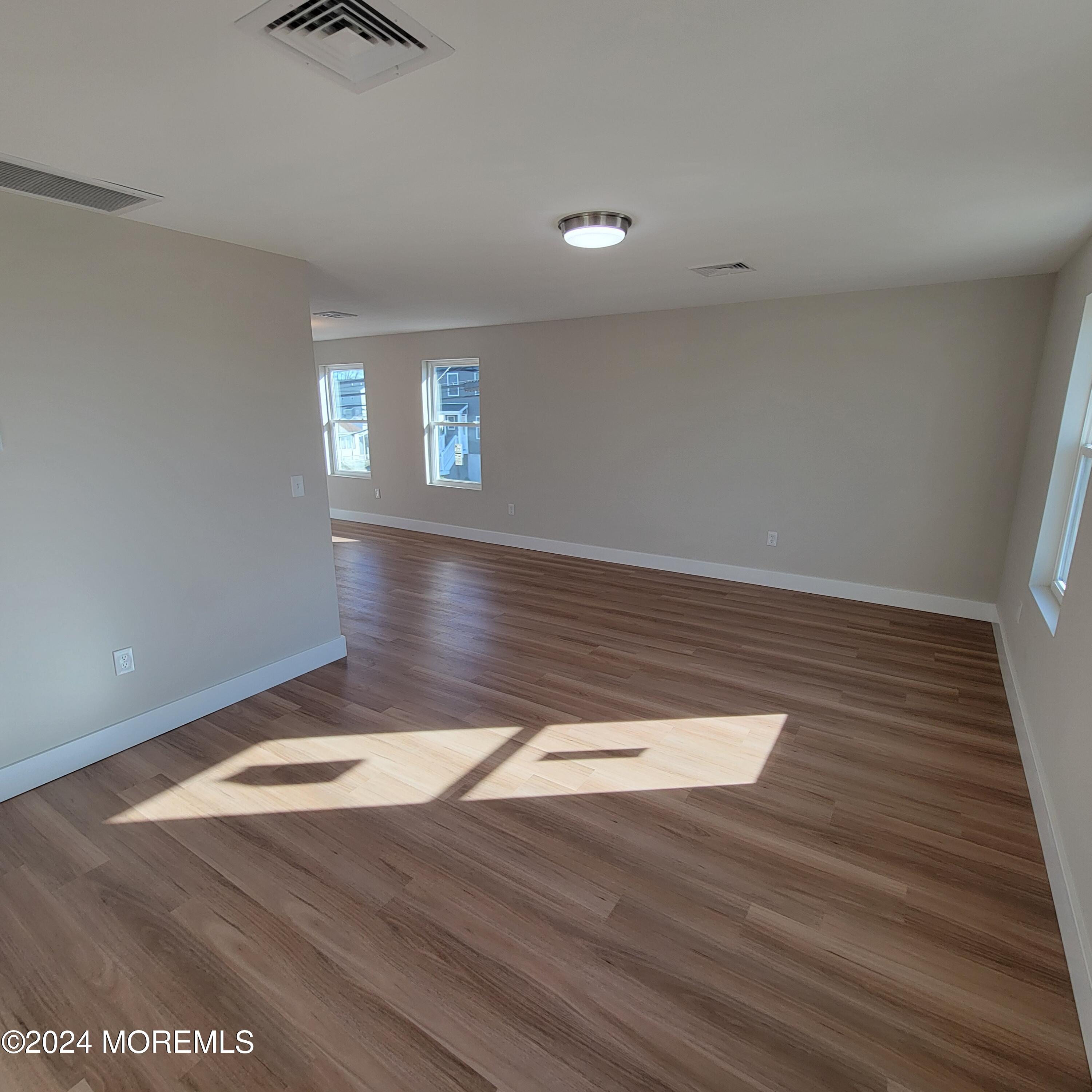 603 Florence Avenue, Unit 2 Union Beach, NJ 07735 - Photo 6 of 11 a view of wooden floor and window in a room