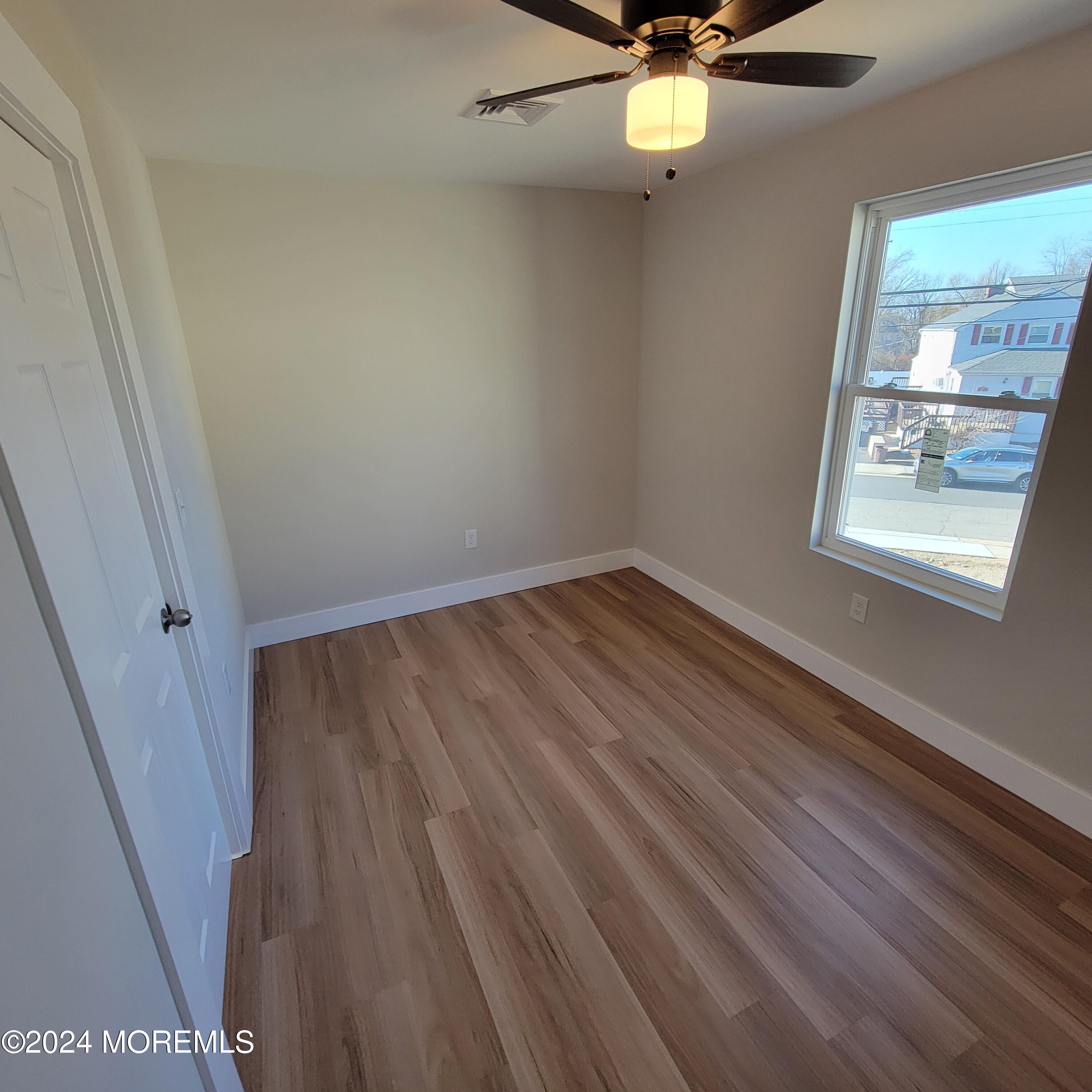 603 Florence Avenue, Unit 2 Union Beach, NJ 07735 - Photo 7 of 11 an empty room with windows and fan