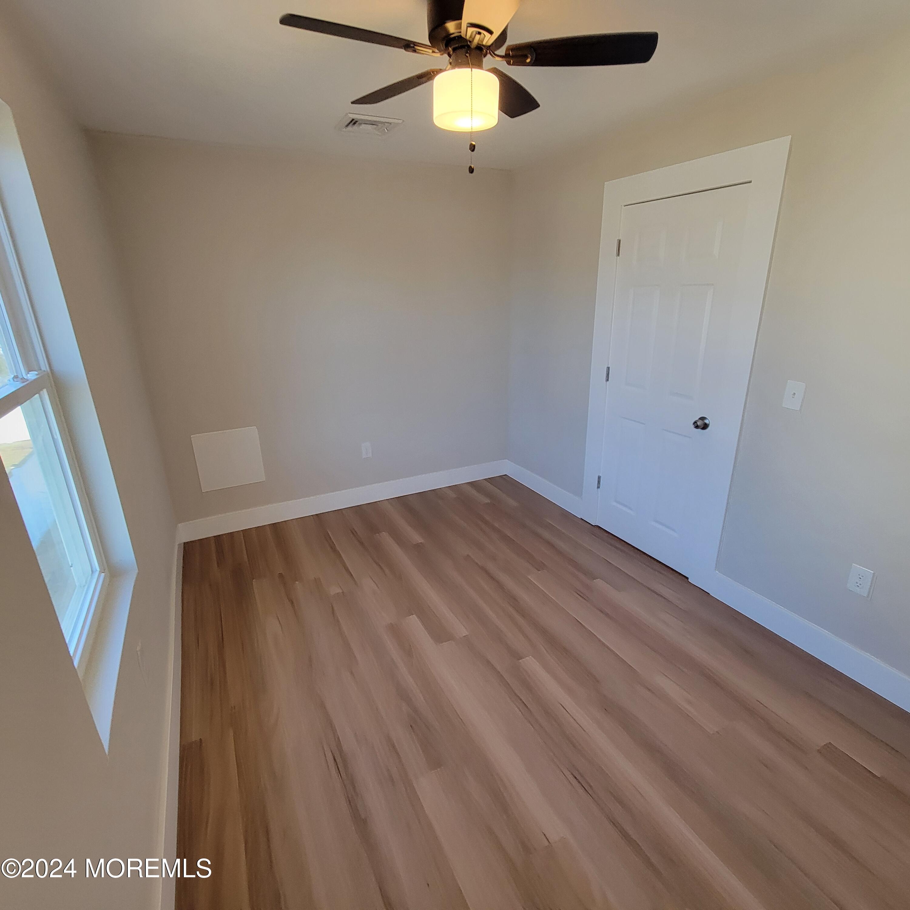 603 Florence Avenue, Unit 2 Union Beach, NJ 07735 - Photo 8 of 11 wooden floor in an empty room with a window