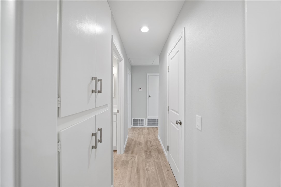 3386 Somis Drive Riverside, CA 92507 - Photo 15 of 31 a view of a hallway with wooden floor and a bathroom