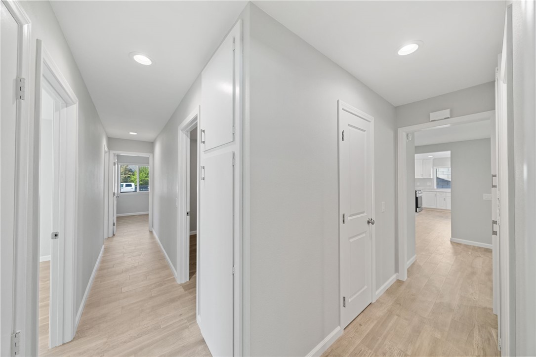 3386 Somis Drive Riverside, CA 92507 - Photo 16 of 31 a view of a hallway with wooden shelves