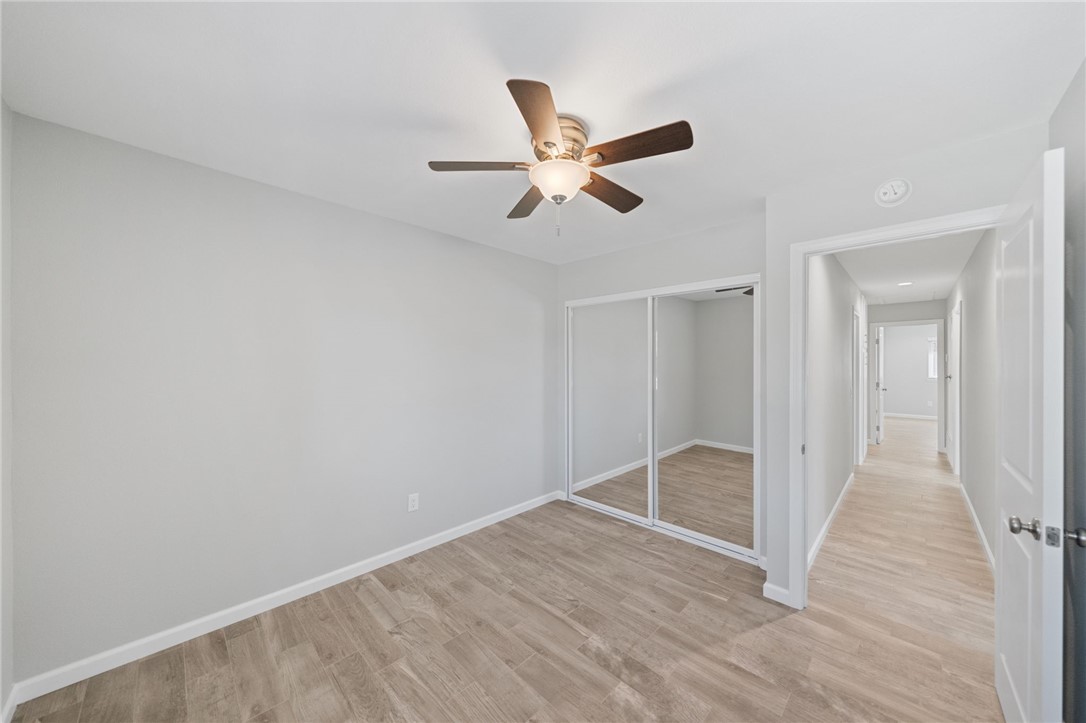 3386 Somis Drive Riverside, CA 92507 - Photo 18 of 31 an empty room with wooden floor and windows