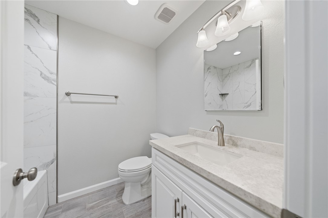 3386 Somis Drive Riverside, CA 92507 - Photo 22 of 31 a bathroom with a sink a toilet and shower