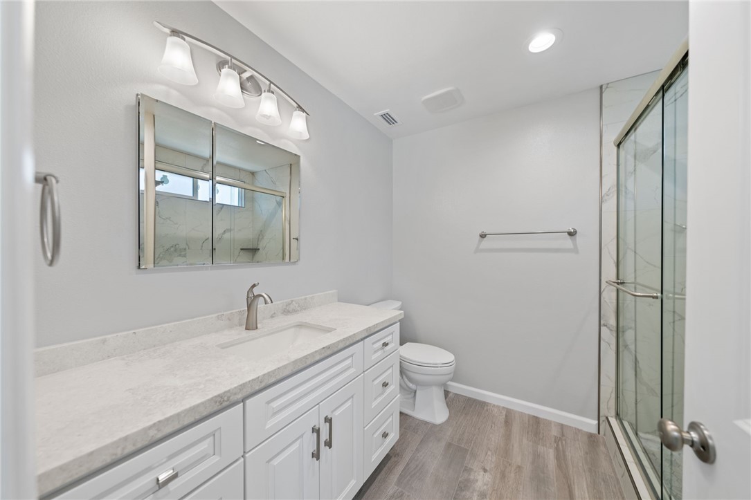 3386 Somis Drive Riverside, CA 92507 - Photo 25 of 31 a bathroom with a sink a toilet and shower