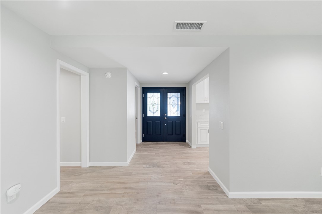 3386 Somis Drive Riverside, CA 92507 - Photo 3 of 31 a view of an empty room with wooden floor and cabinet