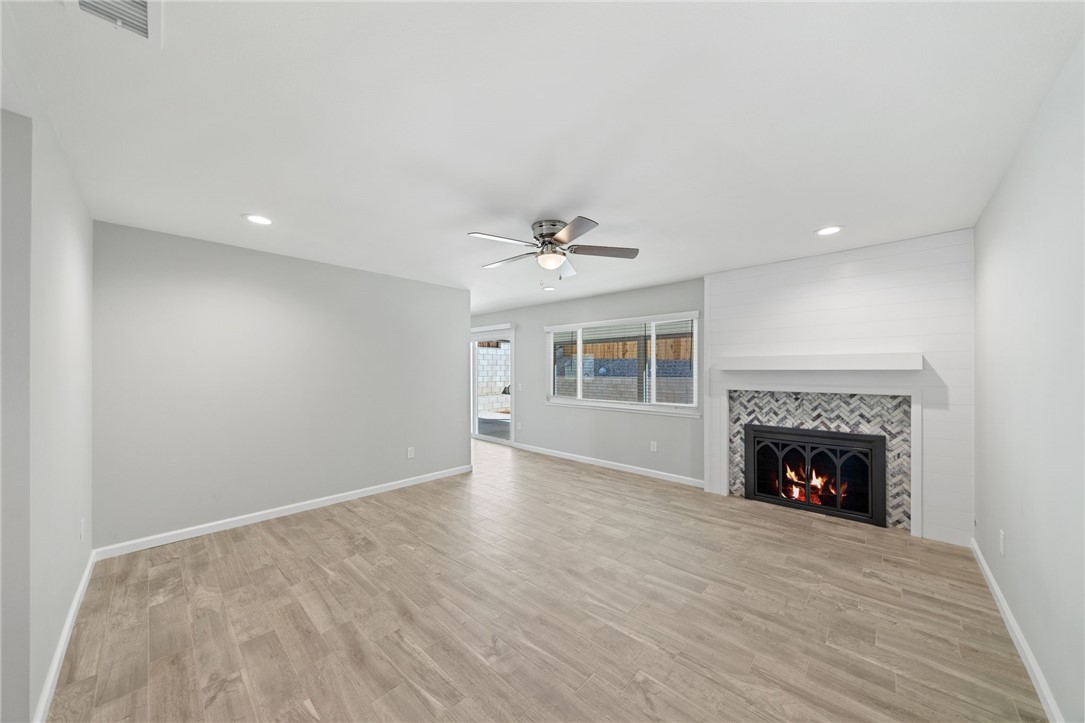 3386 Somis Drive Riverside, CA 92507 - Photo 5 of 31 a view of an empty room with wooden floor fireplace and a window