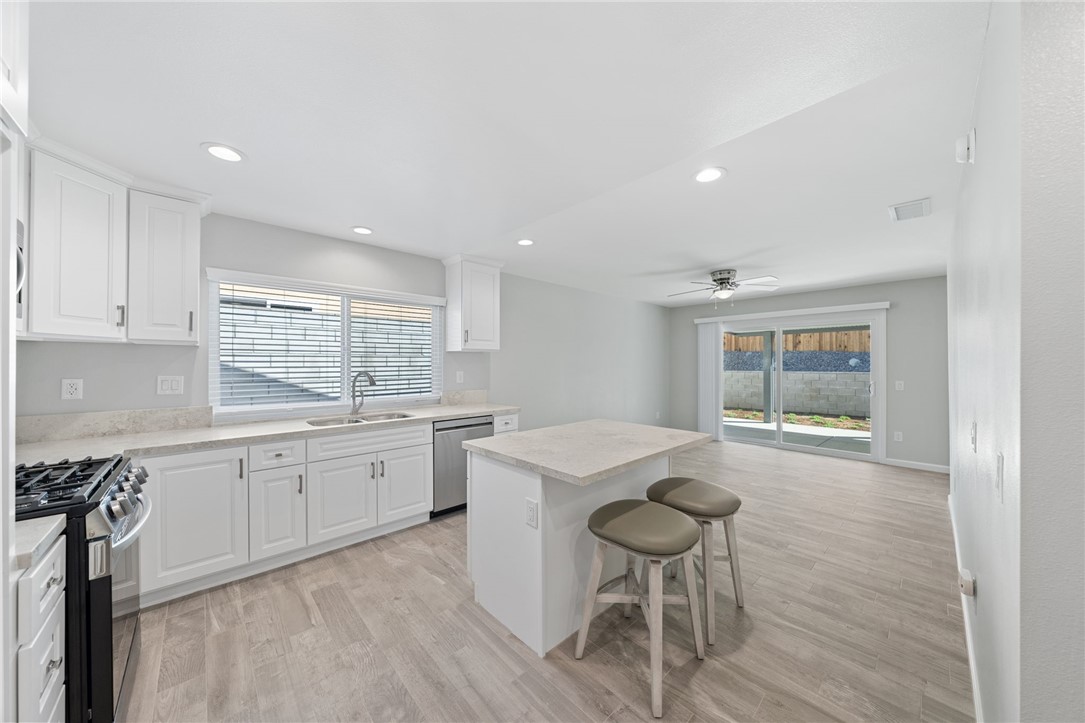 3386 Somis Drive Riverside, CA 92507 - Photo 10 of 31 a kitchen with sink cabinets and wooden floor